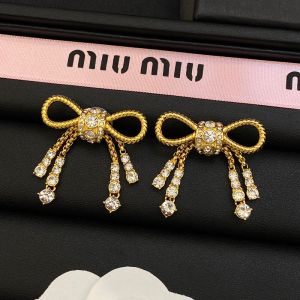 Miu Miu Earrings With Strass Bowknot In Metal Gold